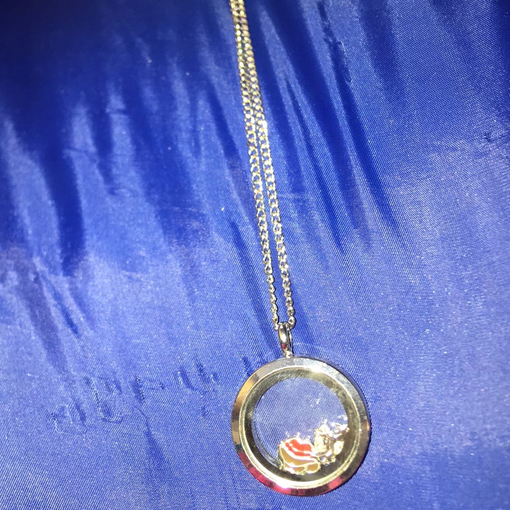 A silver necklace with country related charms.